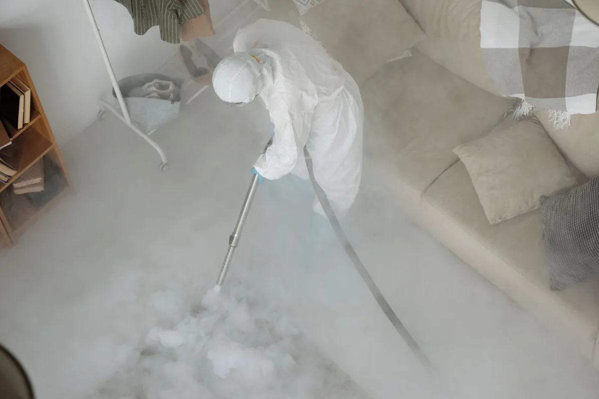Biohazard cleanup technician in protective equipment, Dulce, NM